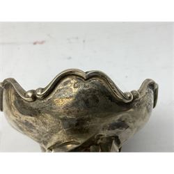 Four hallmarked silver trumpet vases, total weight 108g, upon silver plated stand with foliate decoration and bun feet