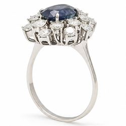 18ct white gold sapphire and diamond cluster ring, single oval cut sapphire of approx 2.10 carat, surrounded by sixteen round brilliant cut diamonds, total diamond weight approx 0.95 carat