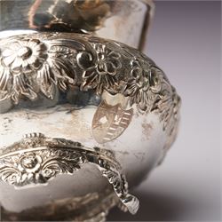 Matched three piece silver tea set comprising teapot of squat circular form London 1827,  milk jug of similar date and sugar bowl with Britannia standard marks, all with later embossed floral decoration and coat of arms, all marks rubbed