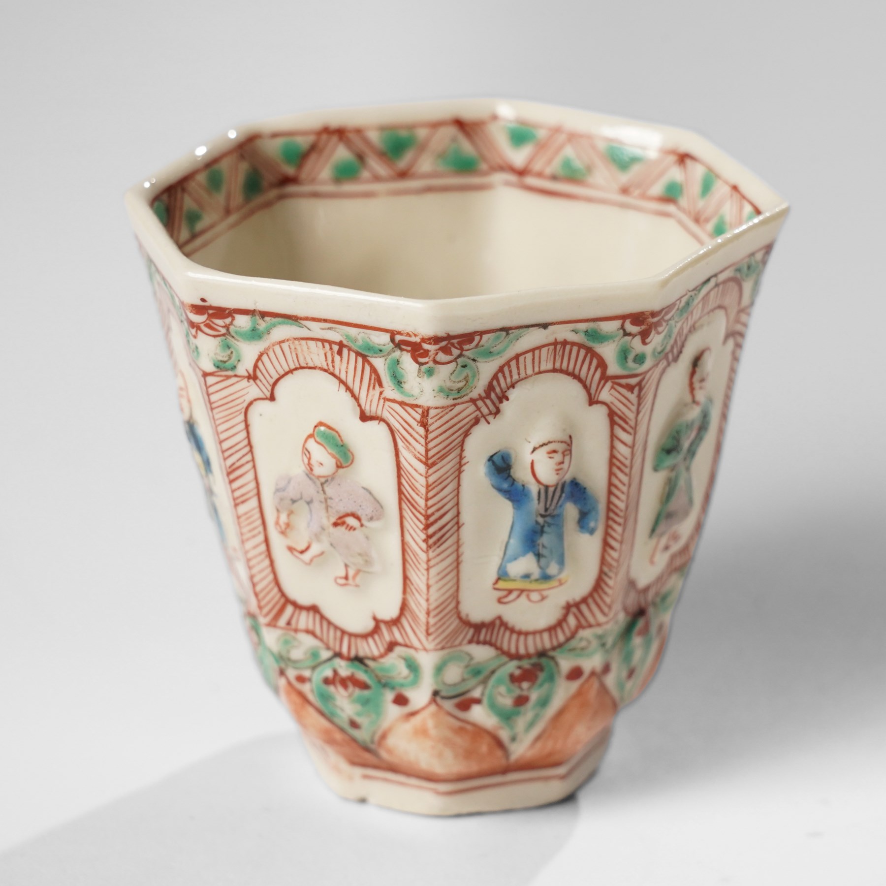 Pair of Chinese Kangxi period Blanc de Chine octagonal 'Immortals' beakers, Dehua, enamelled in Europe, Shi Zhongtun mark to base, H6.5cm (2)