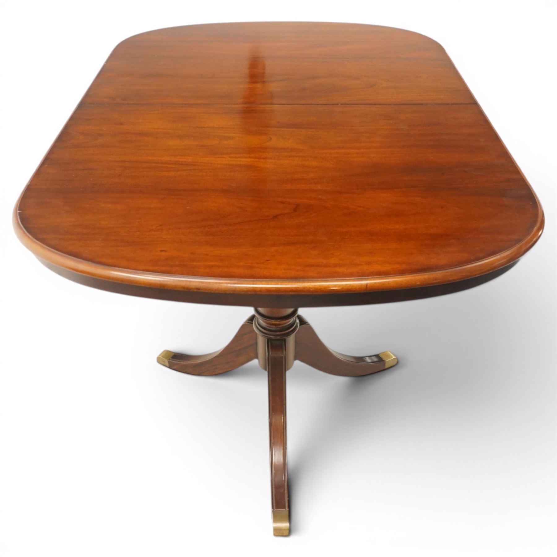 Georgian design mahogany twin pedestal extending dining table, rectangular rounded top on twin tripod pedestals with splayed supports, with additional leaf (W170cm D115cm H77cm); with set six (4+2) matching mahogany framed cameo-back dining chairs, upholstered in pale yellow lozenge patterned fabric (W57cm H94cm)