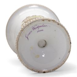 Early 19th century Spode spill vase, of cylindrical form with flared rim, hand painted with a Green Woodpecker perched on a branch, within beaded borders, titled beneath, H16cm, together with a Spode chocolate cup turnover rim stand, decorated in the imari pattern, no. 2630, painted marks beneath, D14cm (2)