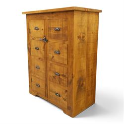 Indigo Furniture - large rustic oak cupboard with faux-drawer fronted cupboard, rectangular top above a cupboard door to the left with latch, a bank of four drawers to the right, metal cup handles raised on shaped supports