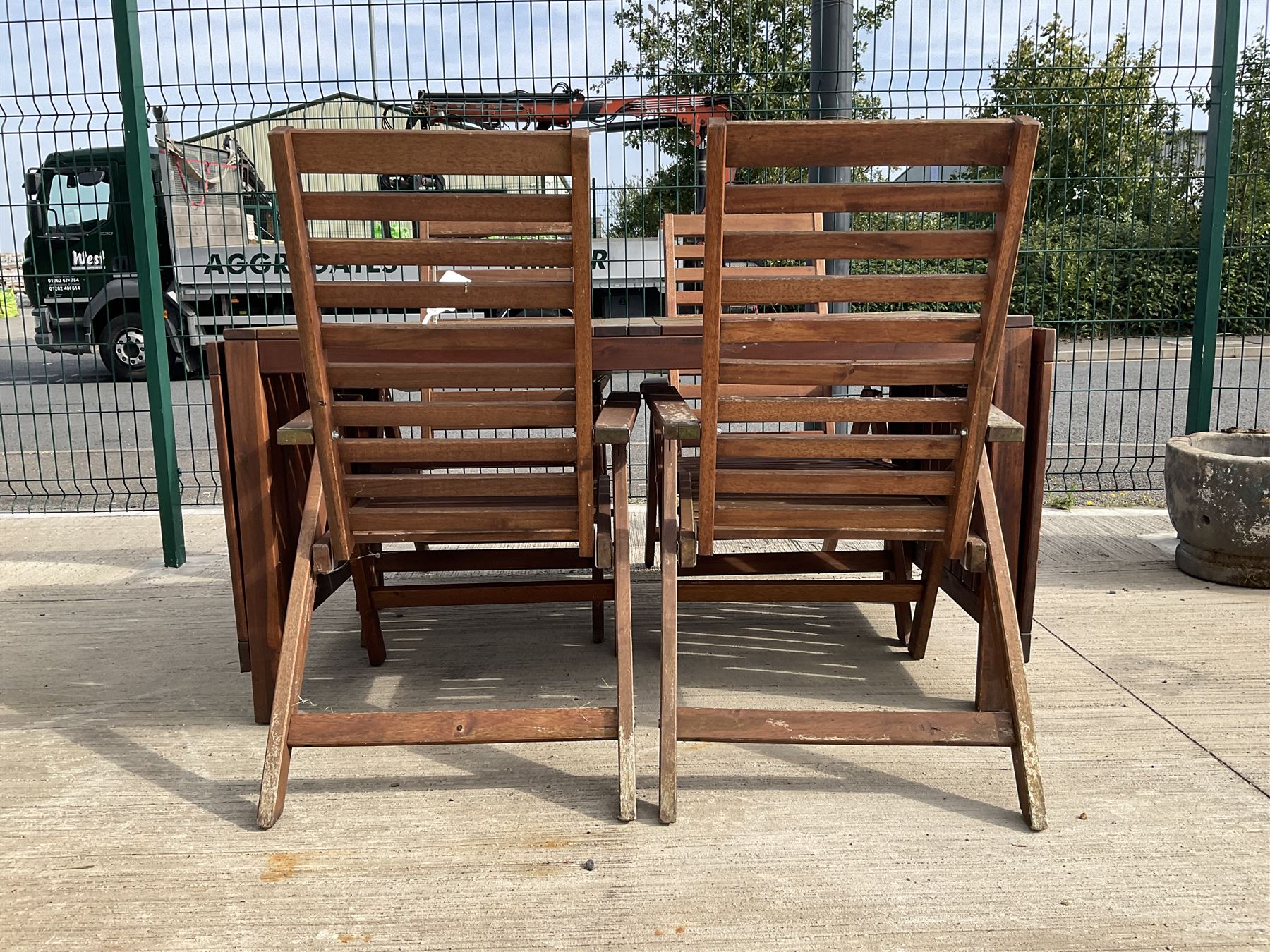 Rectangular teak drop leaf garden table, and four slatted armchairs