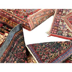 Small Hamadan dark indigo ground rug, central ivory and maroon lozenge with geometric decoration, guarded border with repeating stylised plant motifs, together with three others (4)