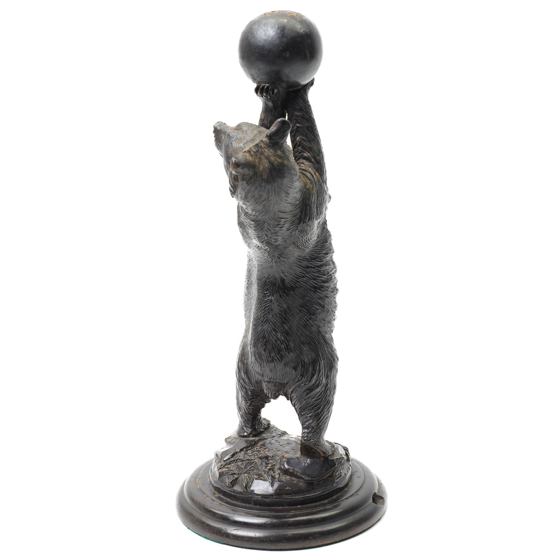 Black forest carving of a circus bear, holding aloft a ball, standing, H35cm