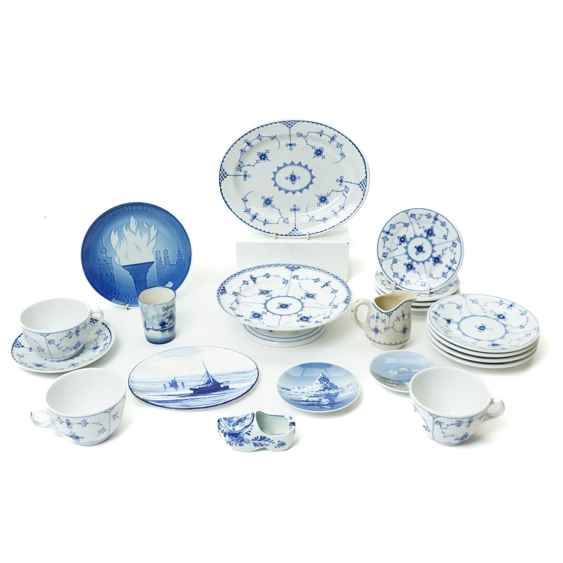 Royal Copenhagen onion pattern low comport, three breakfast cups and five saucers, oval platter, four tea plates, Munich 1972 Olympics plate, and four other blue and white items