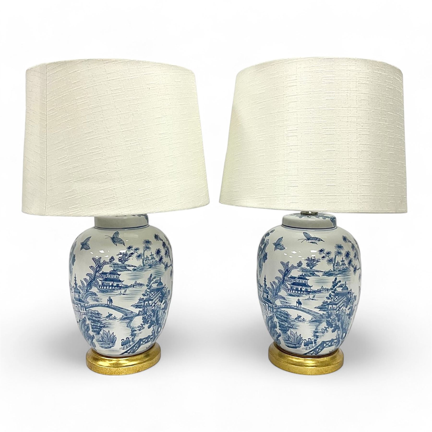 Pair of Chinese table lamps of baluster form, each decorated with landscape scene, raised upon gilt circular base, including shade H63cm