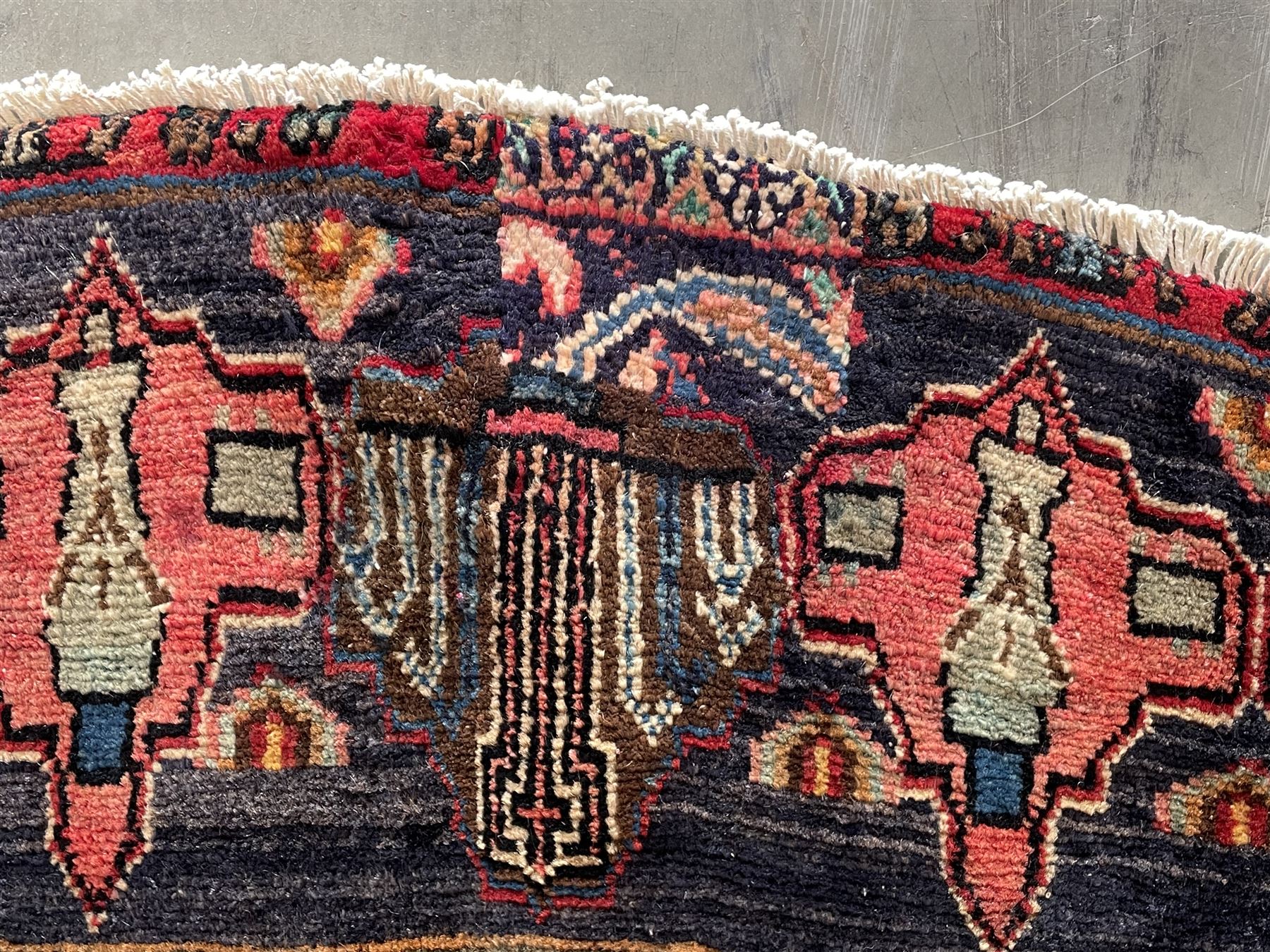 Persian Hamadan blue ground rug, medallion on field decorated with repeating motifs, the guarded border with multiple medallions decorated with flower heads and stylised motifs