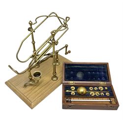 French brass wine pourer with mechanical action all on rectangular wooden base, together with a mahogany cased metal Sykes's Hydrometer