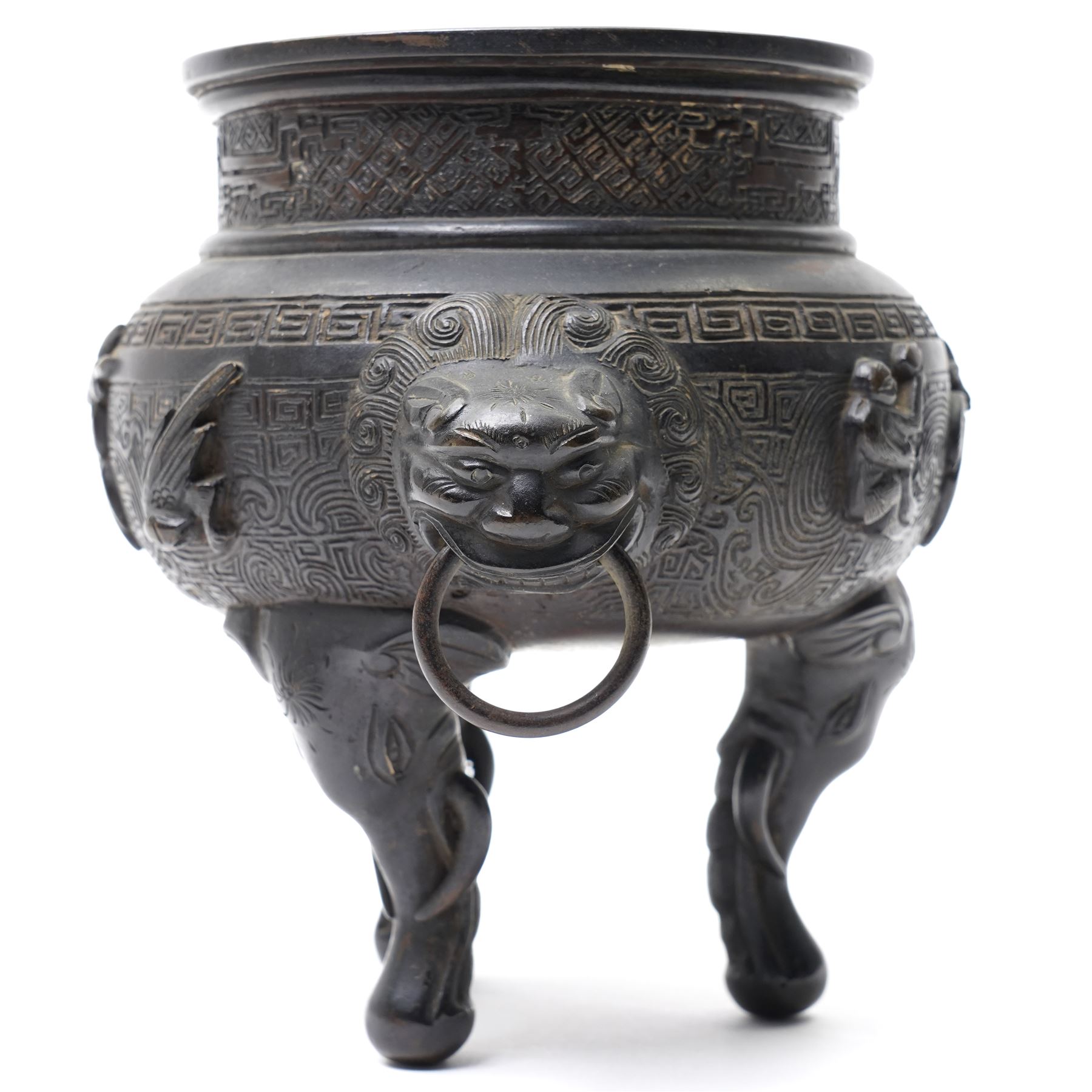 Early 19th century Chinese Qing Dynasty bronze censer, the body of globular form with circular neck and twin cast lion mask ring handles, decorated with applied figures of a monkey, deer and bird, against a key fret detailed ground, the whole upon three zoomorphic elephant feet, H16.4cm D12cm