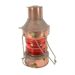 Copper ships lantern with red glass, marked NUC with brass handles and fittings, H46cm