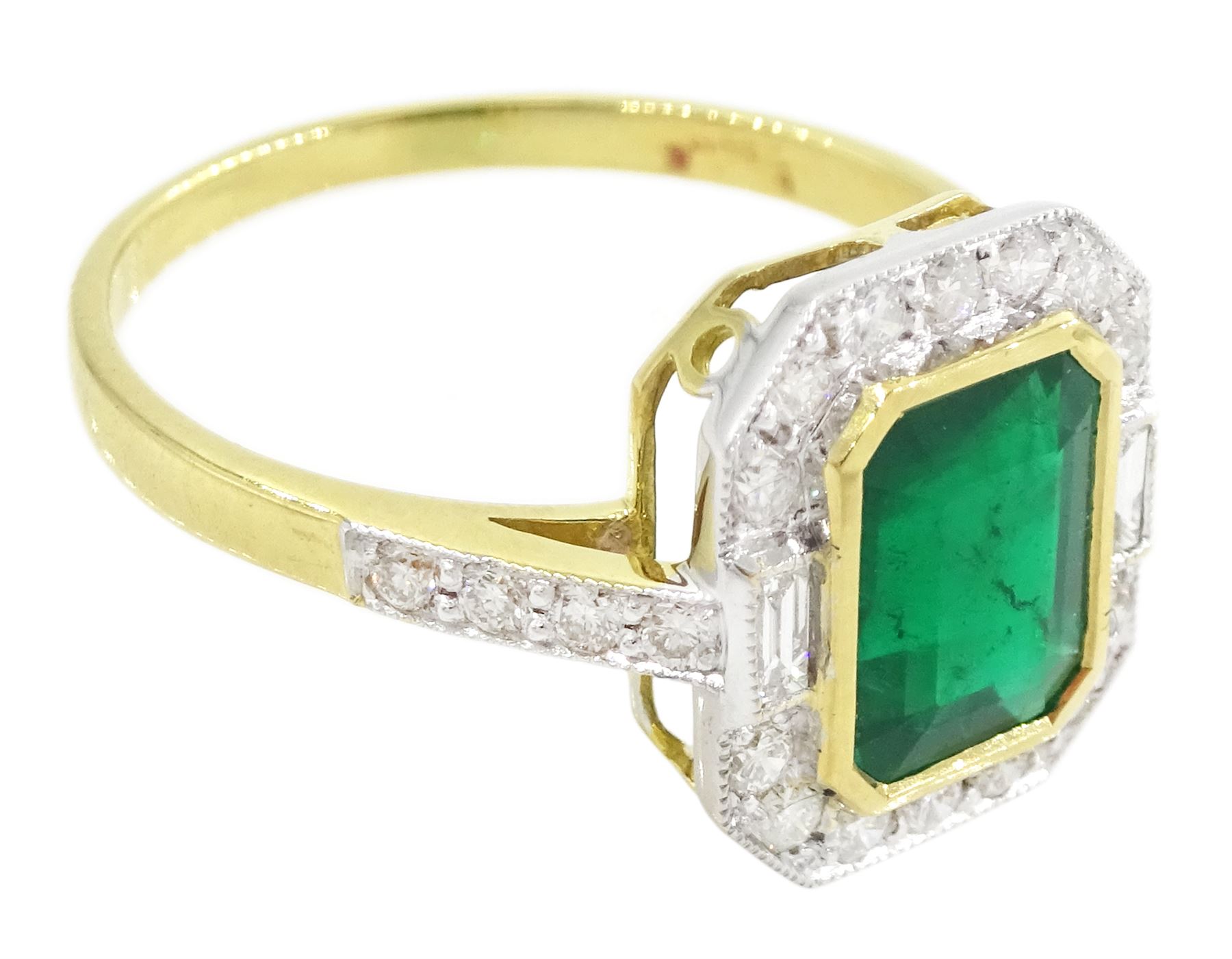 18ct gold emerald and diamond cluster ring, octagonal cut emerald of approx 1.50 carat, with milgrain set, round brilliant and baguette cut diamond surround and diamond set shoulders, stamped 750, total diamond weight approx 0.45 carat