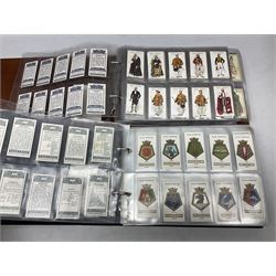 Four modern loose leaf albums containing a large quantity of cigarette cards by Players, Wills, Lambert & Butler and Gallahers including Recruiting Posters, Military Motors, shipping, aviation, military and medals, cricketers and other sporting, horsemanship, royalty etc; three in slip cases (4)