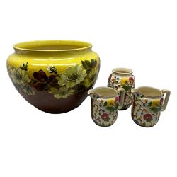 Victorian Leeds Art Pottery jardinière decorated with flowers and foliage on a brown and yellow merging ground, together with H.J. Wood Indian Tree jugs and vase, jardinière D37cm
