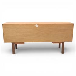G-Plan - ‘Brasilia’ teak sideboard, rectangular top with moulded edge above a central bank of four drawers flanked by cupboard doors with carved sculptural handles, raised on tapering supports
