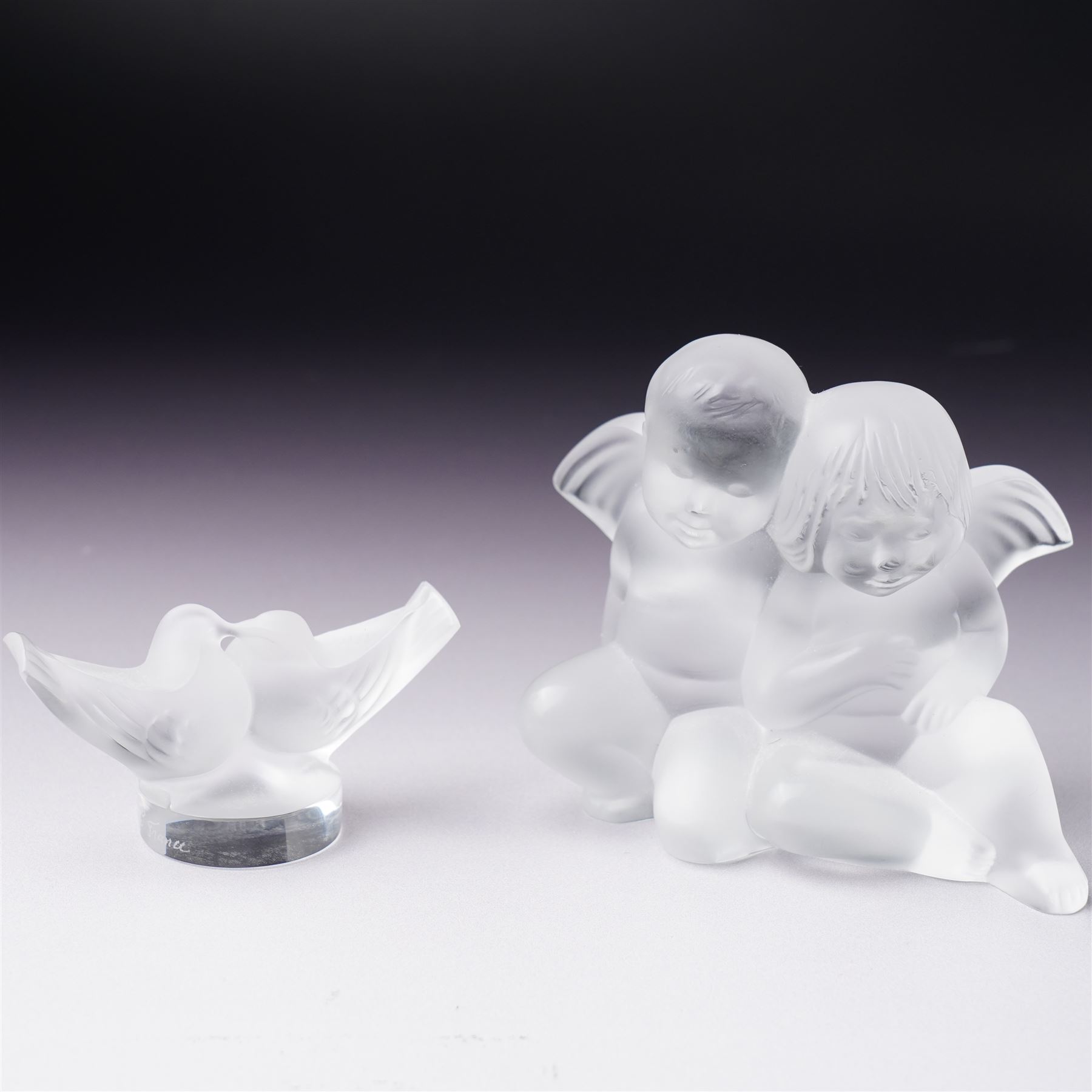  Lalique frosted glass figure of two cherubs  H8cm and another of two doves H4cm, both marked 'Lalique, France' (2)