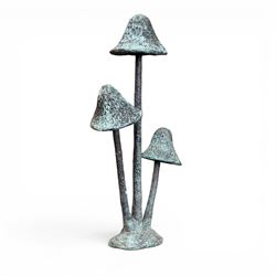 Bronze garden ornament in the form of three mushroom stalks, on naturalistic base