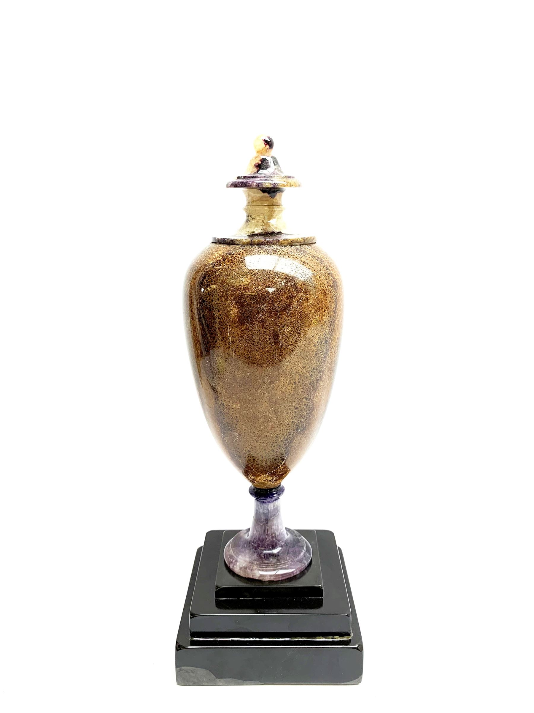 Early 19th century and later Blue John urn, Winnats one vein, of ovoid form with integrated cover and ball finial, upon a spreading circular base, and square stepped black lacquered base, H34.5cm