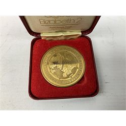 Queen Elizabeth II cradle of civilization cruise 1976 bronze medallion with related book and two other Queen Elizabeth II commemorative medallions for cruises in 1975 and 1976, all cased