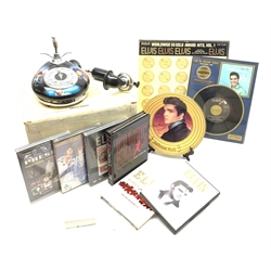 Elvis Presley - Bradford Exchange limited edition telephone, boxed with paperwork; framed 'Are You Lonesome Tonight' 45rpm record; six DVDs; RCA Victor boxed set of four LP records; collector's plate on stand; and unused notepad