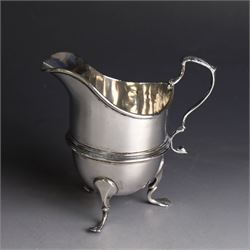 Late Victorian silver helmet shaped cream jug, with acanthus capped handle and upon three pad feet, hallmarked Birmingham 1898, maker's mark worn and indistinct, probably T Beardsmore, H10cm