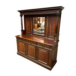 Late Victorian mahogany mirror back sideboard, projecting cornice with egg and dart carving over an arcade carved frieze, supports by fluted columns with composite capitals, rectangular bevelled plate within gadrooned frame flanked by fielded panels with foliate slips, fitted with three drawers over three cupboards, the right containing cellarette drawer