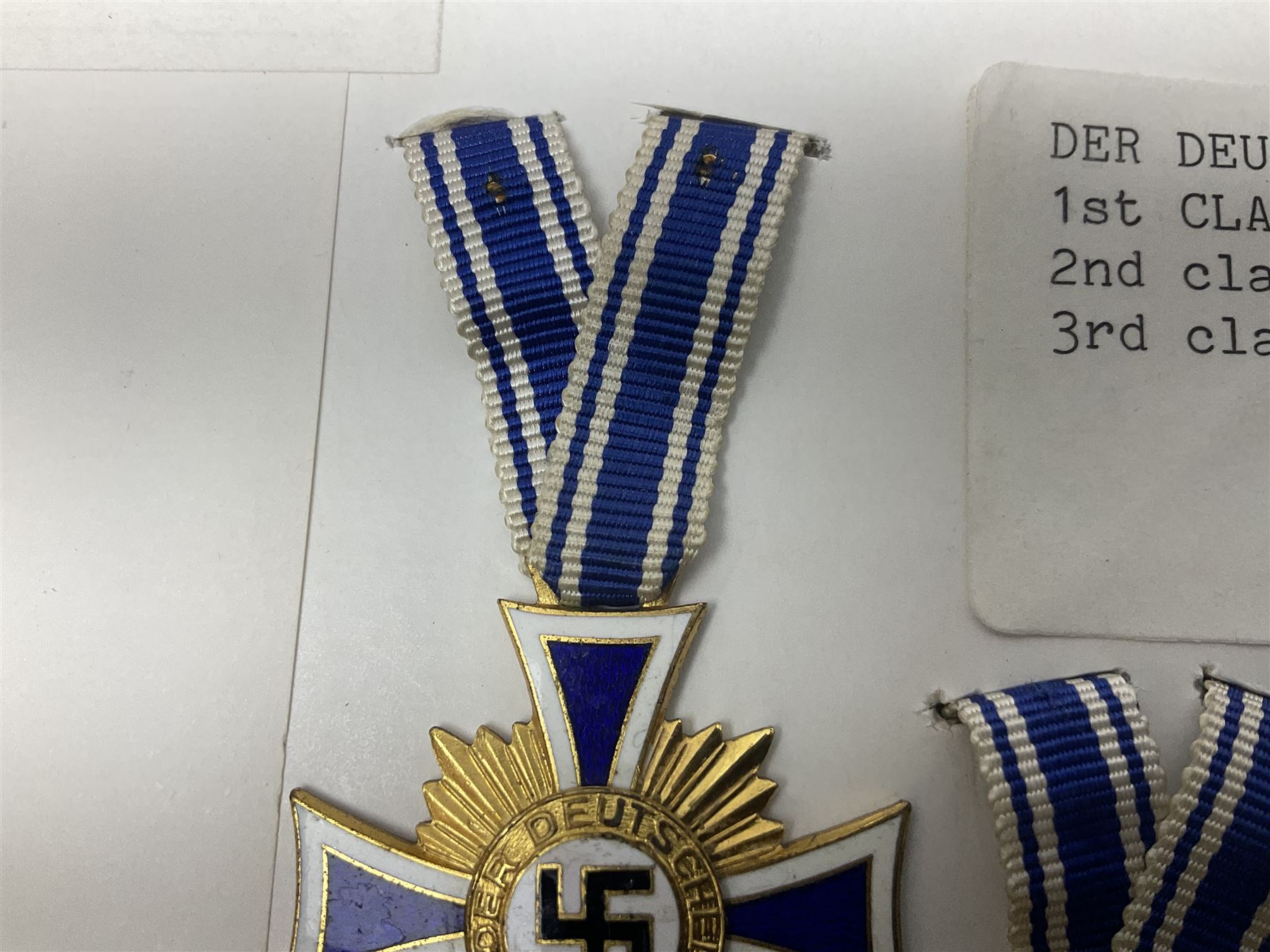 WWII set of three German Mother's Crosses, 1st Class in gilt, 2nd Class in silver and 3rd Class in bronze; all with ribbons (3)
