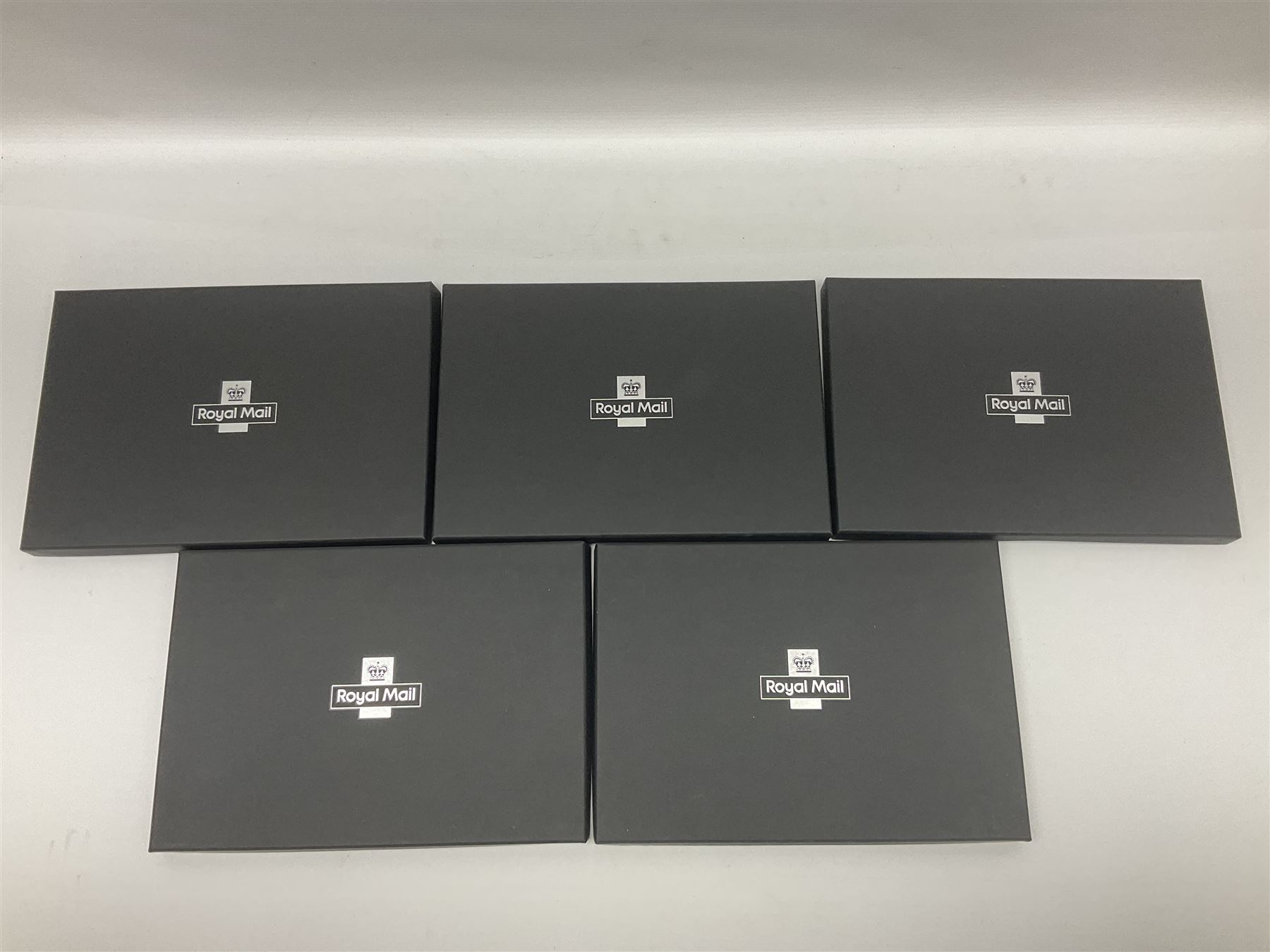 Five The Royal Mint Royal Mail silver proof coin covers, comprising 2021 'HG Wells' with two pounds, 2021 'HM The Queen's 95th Birthday' with five pounds, 2022 'Her Majesty The Queen's Platinum Jubilee 70 Years' with five pounds, 2022 'Her Majesty The Queen's Platinum Jubilee 70 Years' with fifty pence and 2022 '150 Years of The FA Cup' with two pounds, all in Royal Mail card boxes