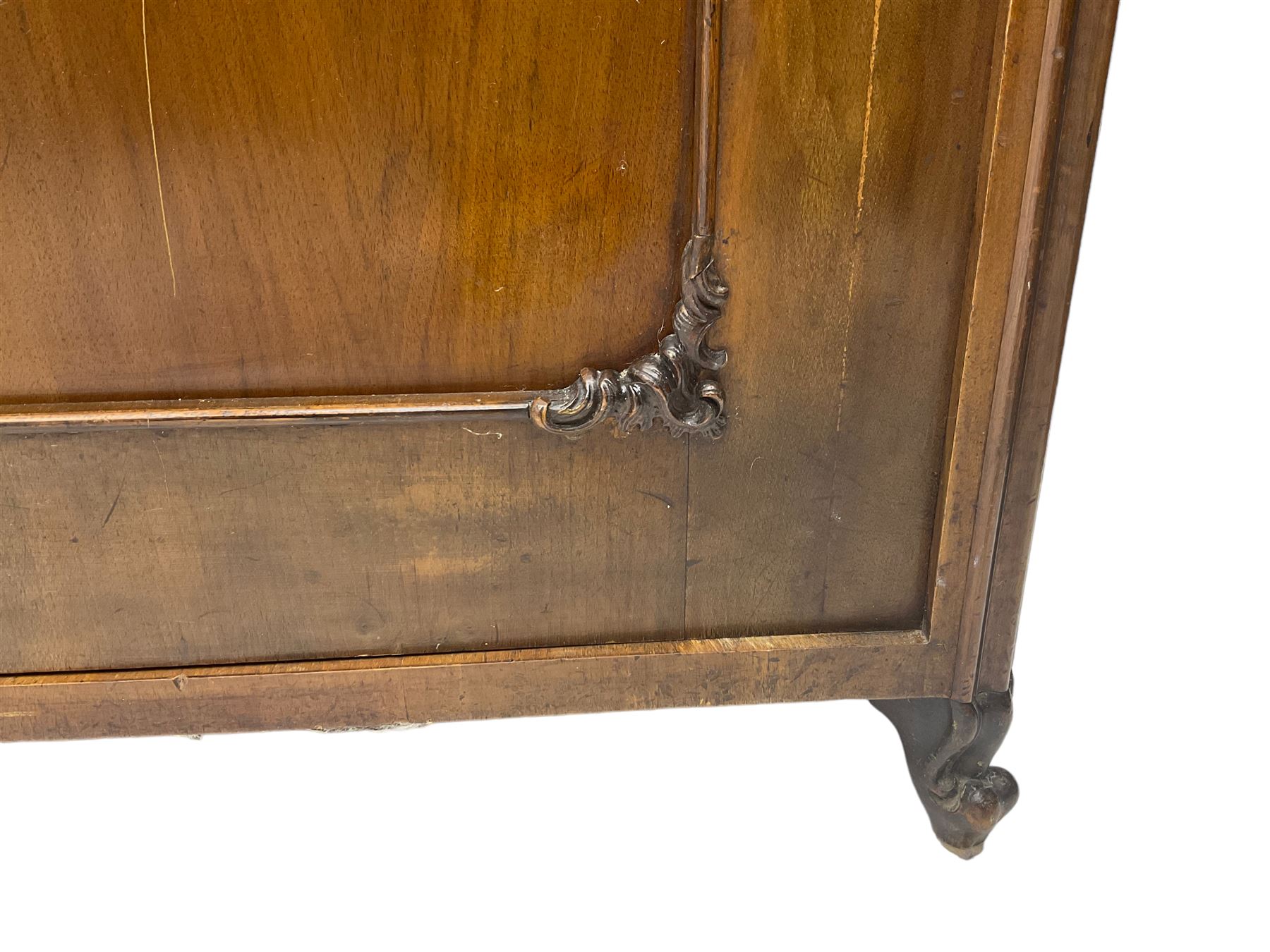 Early 20th century Italian walnut armoire wardrobe, the pierced and scrolling pediment carved with acanthus leaf detail, flanked by two scrolling cartouche with matching corbels below, the two panelled doors with applied carved rinceaux slips, with a central spiral turned upright, enclosing single shelf and hanging rail, raised on scroll feet