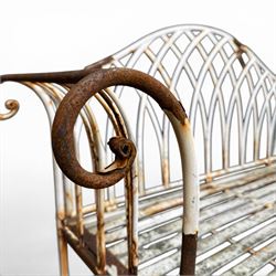 Small wrought metal two seat garden bench, finished in distressed white paint