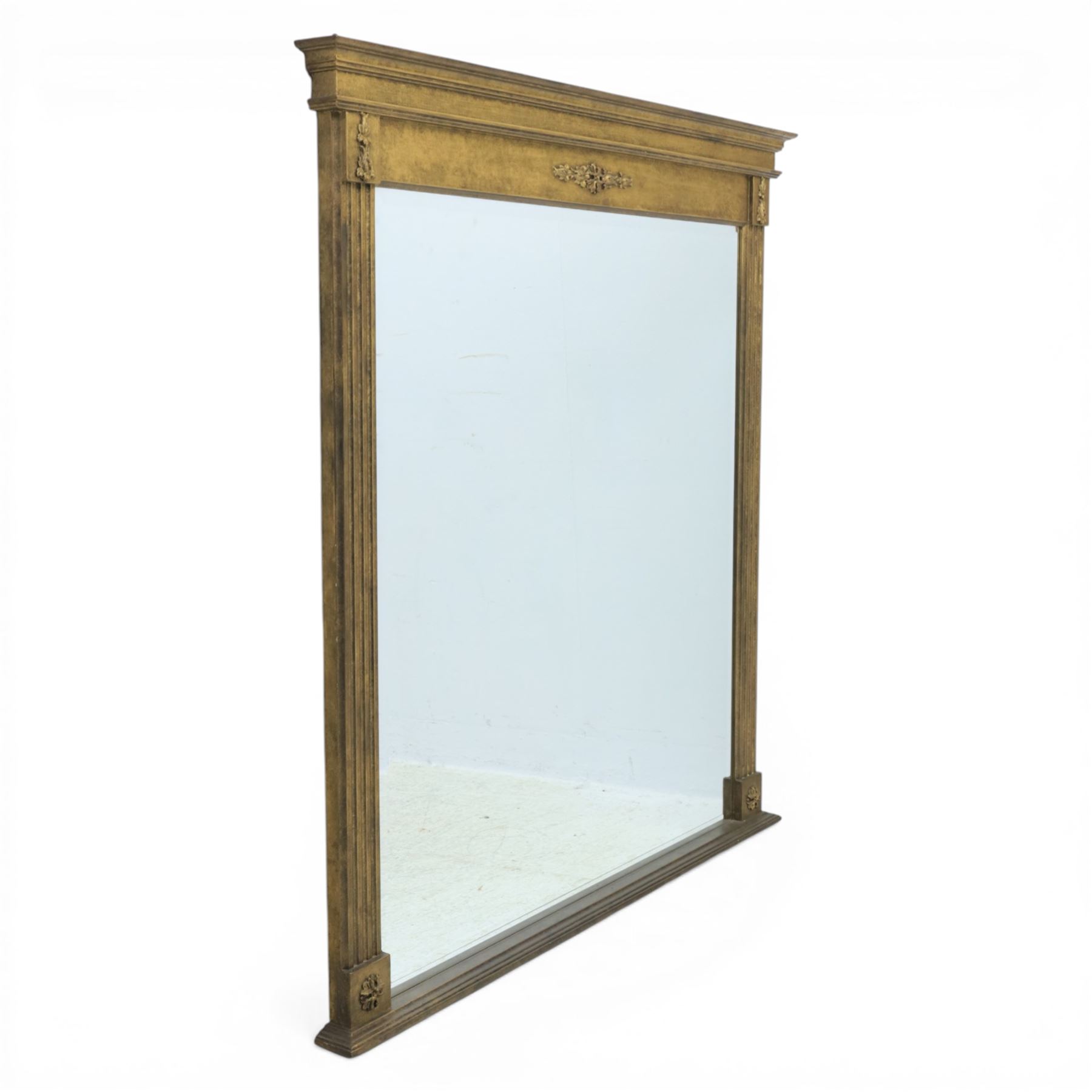 Late 20th century neoclassical style gilt wall mirror, the moulded cornice above a plain frieze centred with foliate mount, fluted pilaster sides with applied ornament, on moulded plinth base surrounding a rectangular mirror plate