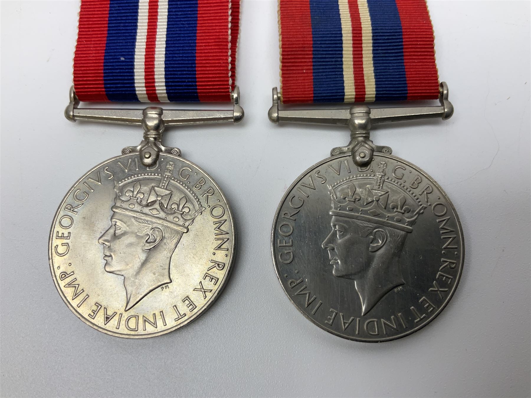 Ten WW2 medals comprising two 1939-1945 war medals, two Defence medals, two 1939-1945 Stars, two Africa Stars, France & Germany Star and Burma Star; together with bar of four miniature medals; all with ribbons