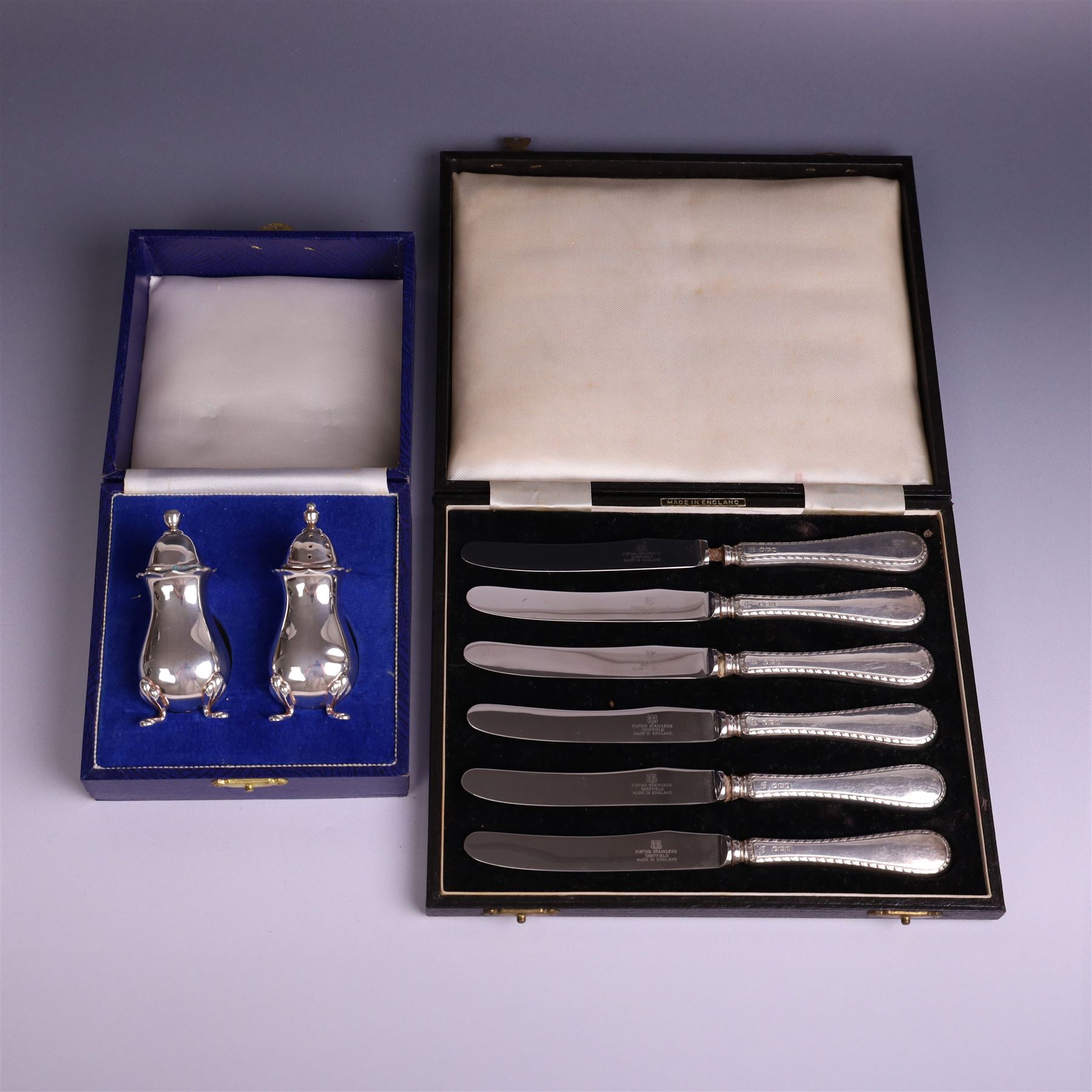 Pair of silver cruets, of baluster form and upon four pad feet, hallmarked Laurence R Watson & Co, Birmingham 1993, together with a set of six silver handled tea knives, hallmarked Barker Brothers Silver Ltd, Sheffield 1955, both in fitted cases