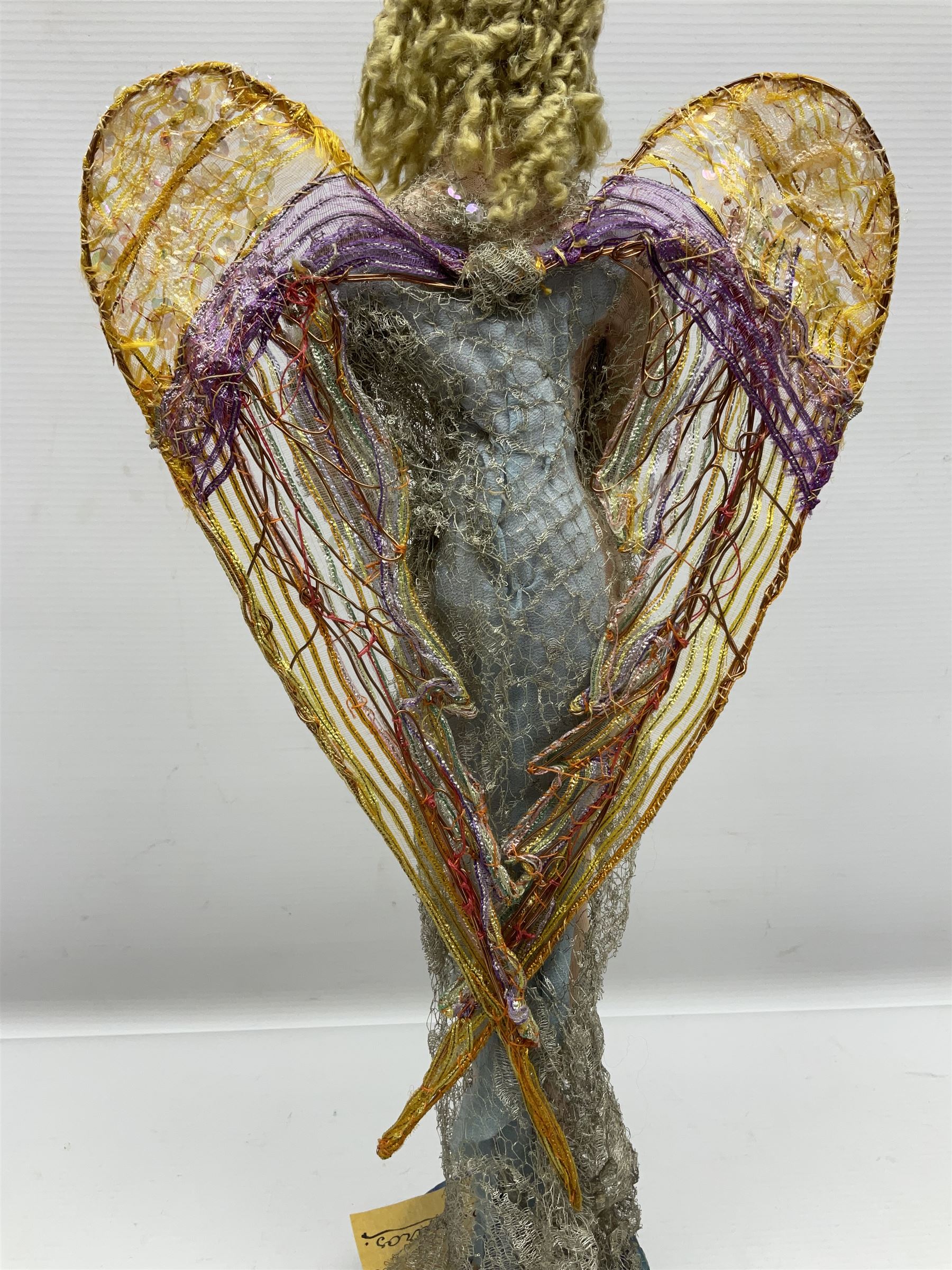 Anna Meszaros Hungary - hand made needlework figurine of an Angel with metallic lace full length dress and open threadwork wings; on moulded base H45cm Auctioneer's Note: Anna Meszaros came to England from her native Hungary in 1959 to marry an English businessman she met while demonstrating her art at the 1958 Brussels Exhibition. Shortly before she left for England she was awarded the title of Folk Artist Master by the Hungarian Government. Anna was a gifted painter of mainly portraits and sculptress before starting to make her figurines which are completely hand made and unique, each with a character and expression of its own. The hands, feet and face are sculptured by layering the material and pulling the features into place with needle and thread. She died in Hull in 1998.