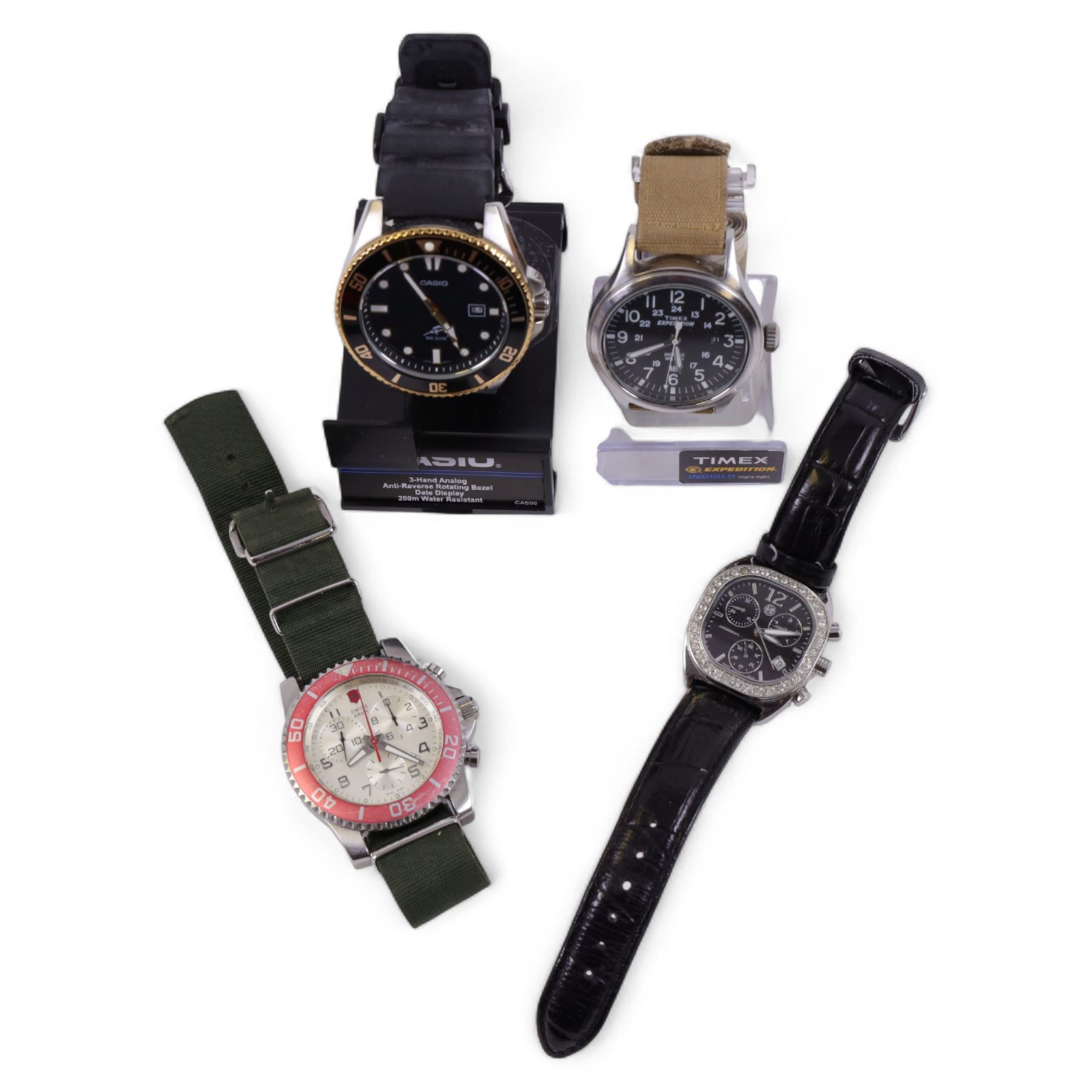 Four quartz wristwatches including Swiss Army chronograph, Timex Expedition, Casio and Alfa Romeo