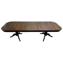Walnut extending dining table, rectangular extending top with rounded corners, with additional leaf, on twin turned pedestals with splayed supports 