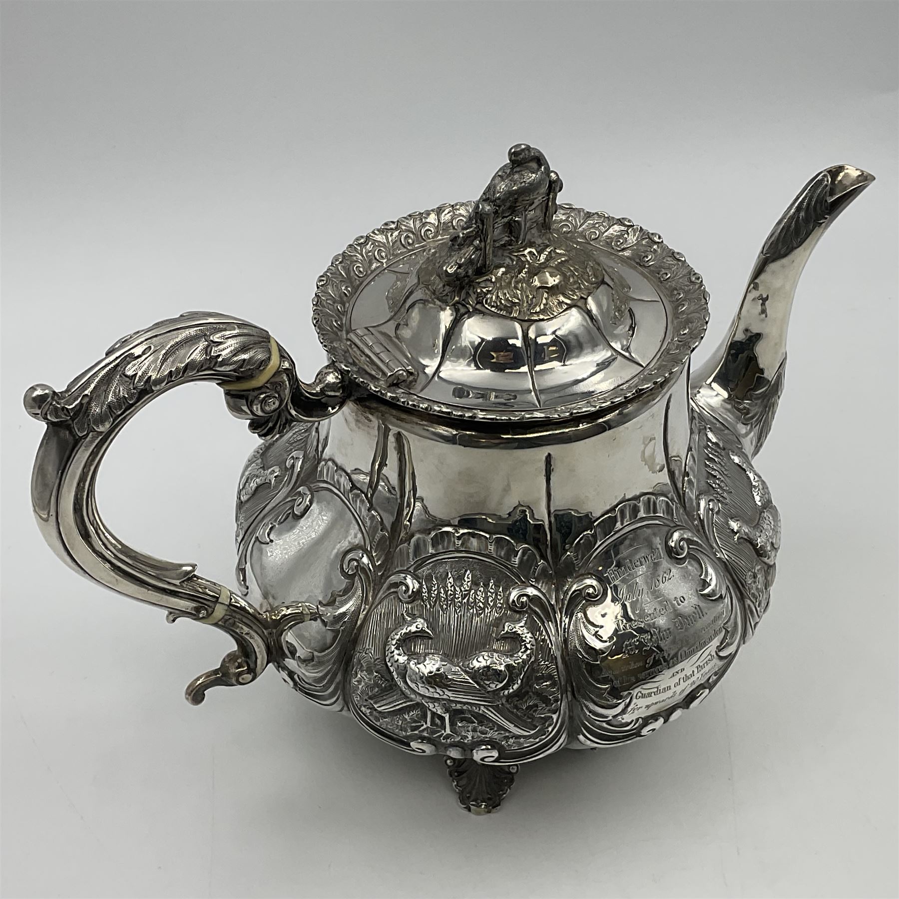 Victorian silver three piece tea service, comprising teapot, twin handled open sucrier, and milk jug, each of bellied form with acanthus capped scroll handles, the sides embossed with alternating scroll edged vacant panels and panels containing a pair of birds, upon four palmette feet, the teapot with ivory insulators to handle, and bird finial to the hinged domed cover, hallmarked William Hunter & Son, London 1861, teapot H19cm, including handles sucrier H13.5cm, including handle milk jug H12cm

This item has been registered for sale under Section 10 of the APHA Ivory Act