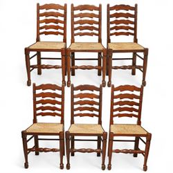 Mid-20th-century set of six elm ladderback chairs, with rush seat and five shaped horizontal back splats, turned front legs, and stretchers 