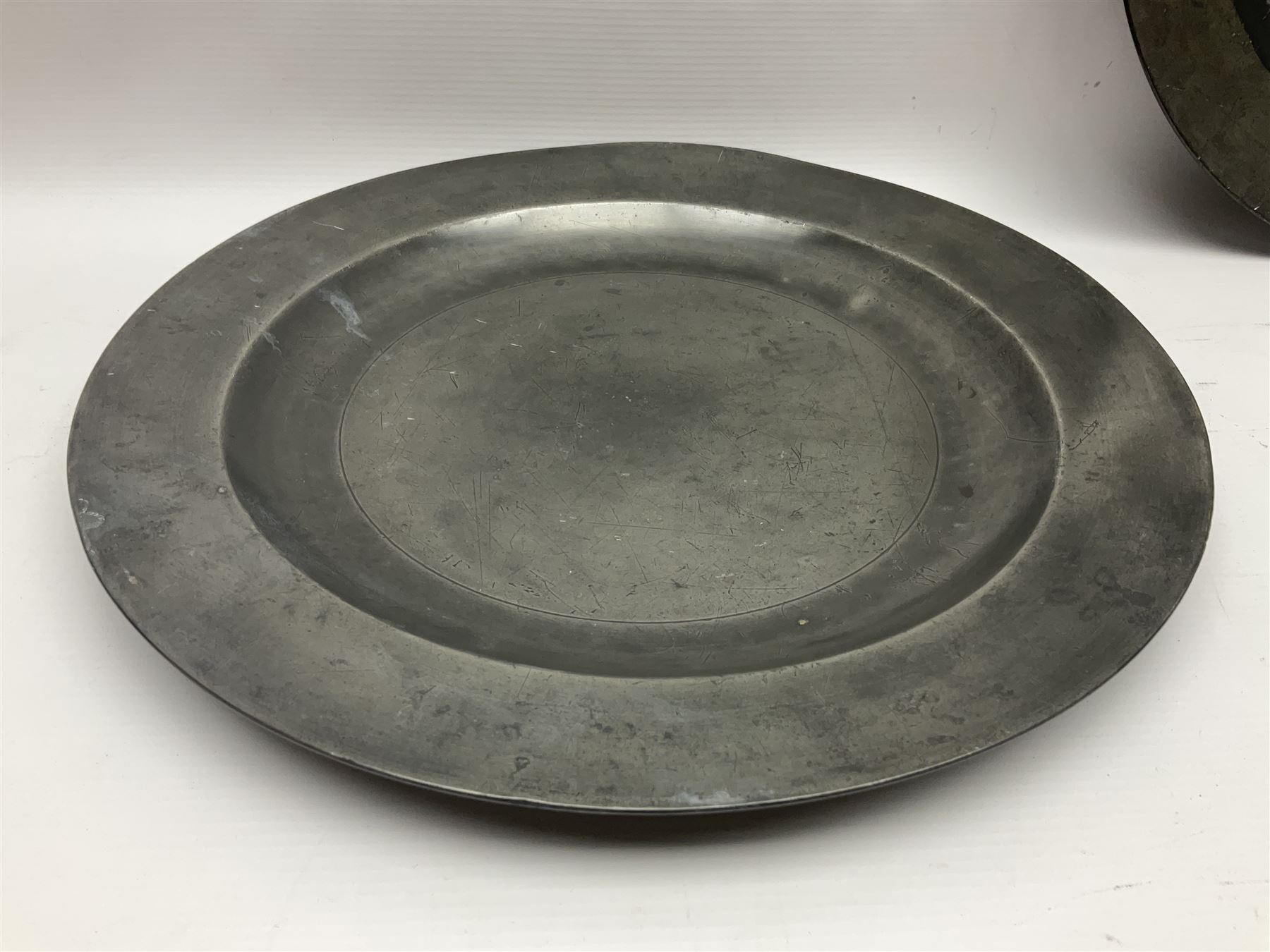 Group of seven 19th century pewter chargers, each of circular form with dished centre, two examples with touch marks verso, each approximately D39cm