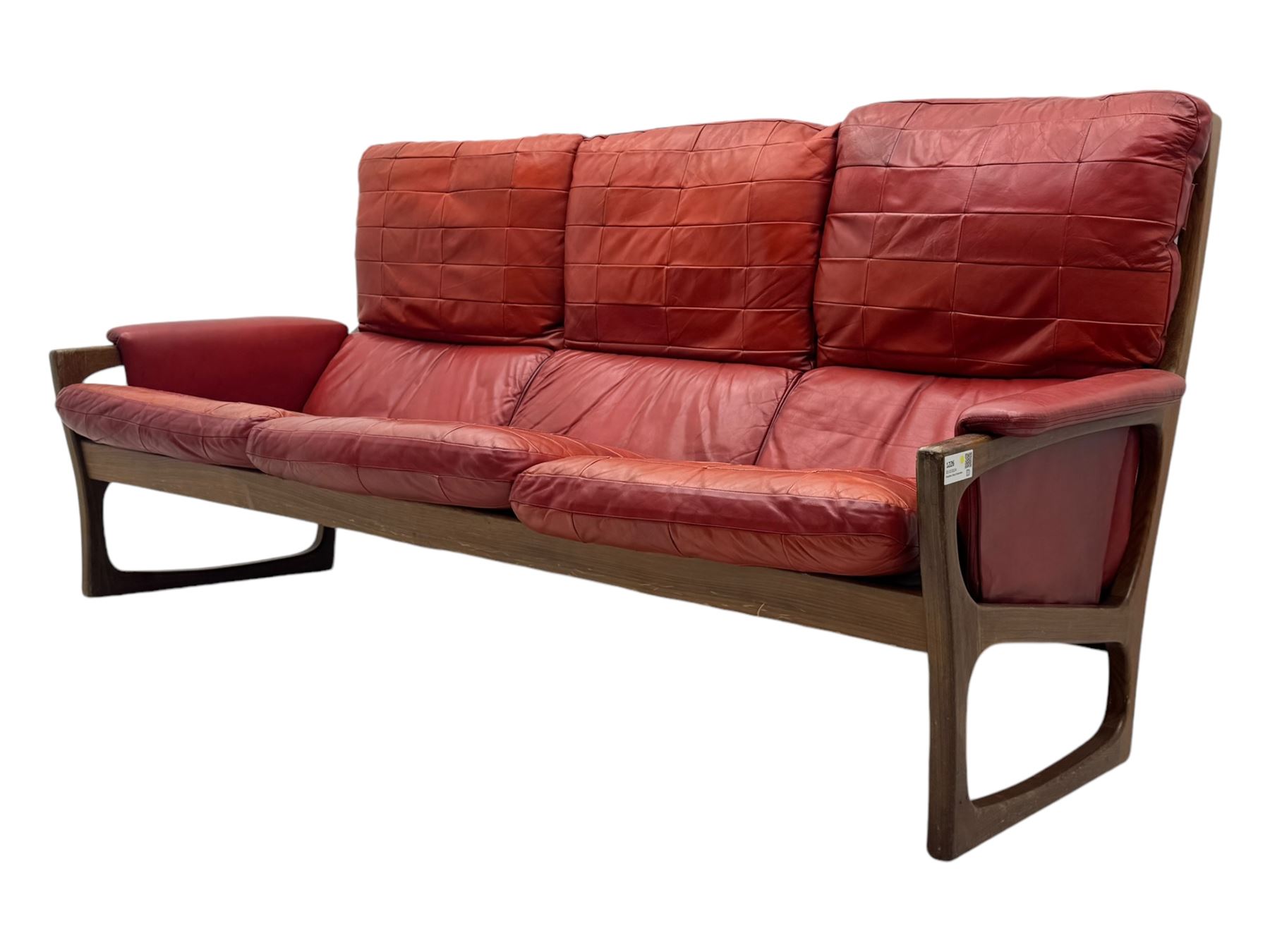 Folke Ohlsson for Gimson & Slater - mid-20th century Danish teak-framed sofa, red leather upholstery with patchwork design, raised on shaped teak side supports