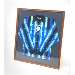 England Youth goalkeeper's shirt worn by Paul Robinson on his first international appearance for England and signed by him, mounted in a wall hanging display frame 89 x 80cm. Provenance: the vendor was a coach at Robinson's club Leeds United and was given the shirt by him.