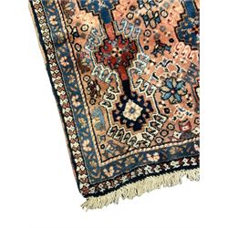 Persian prayer purple ground, decorated with three pointed buildings over tailing lozenge patterned field (111cm x 82cm); and a small Persian rug or mat, overall geometric design (81cm x 56cm)