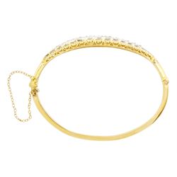 Early 20th century gold and silver diamond hinged bangle, thirteen graduating old cut diamonds, within a fancy scroll design gallery, total diamond weight approx 2.10 carat