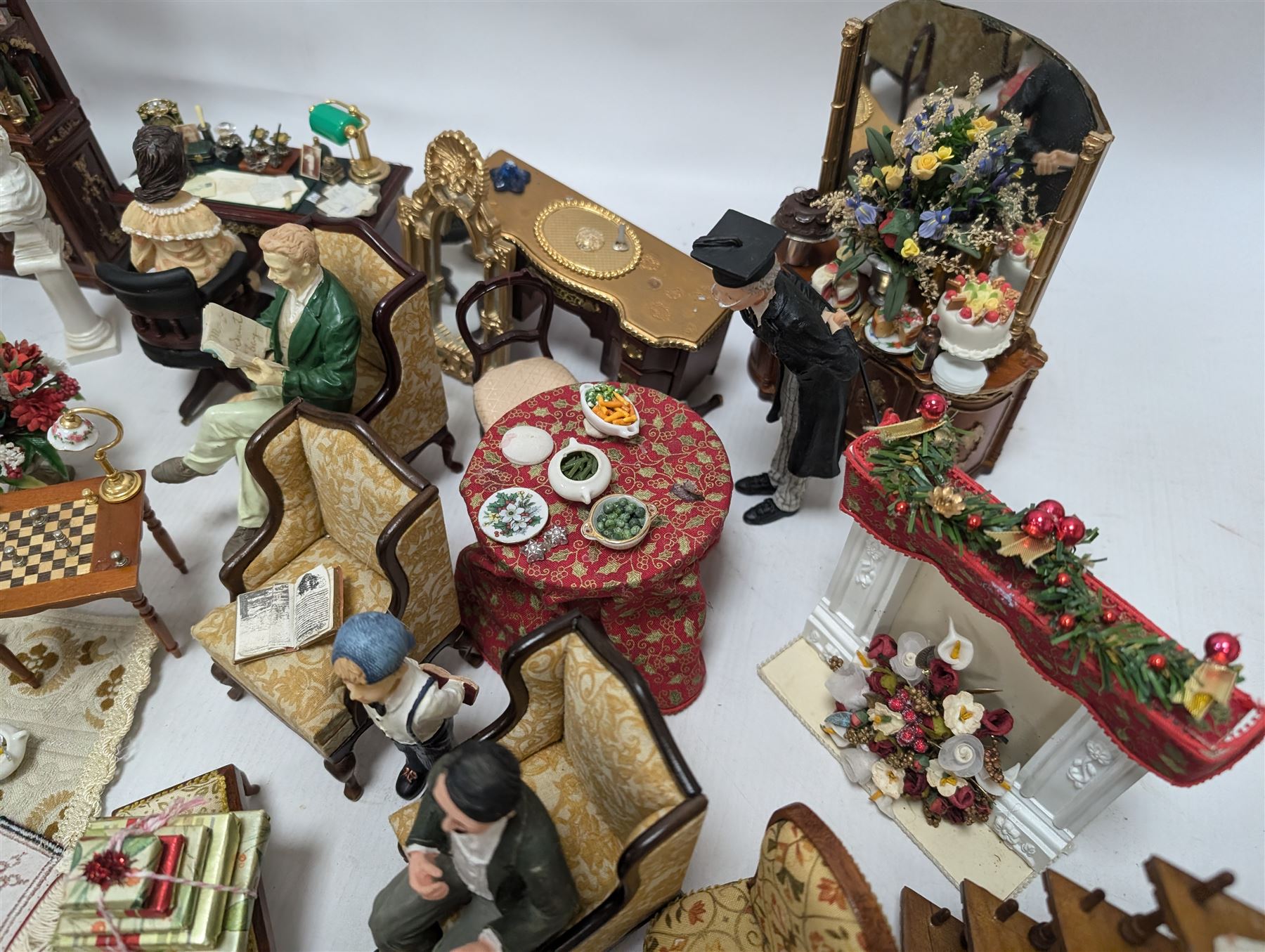 Dolls house living room and dining room furniture, including arm chairs, desk, fireplaces, dressers, tables, eight figures and a large collection of predominantly Christmas themed food, accessories and decorations