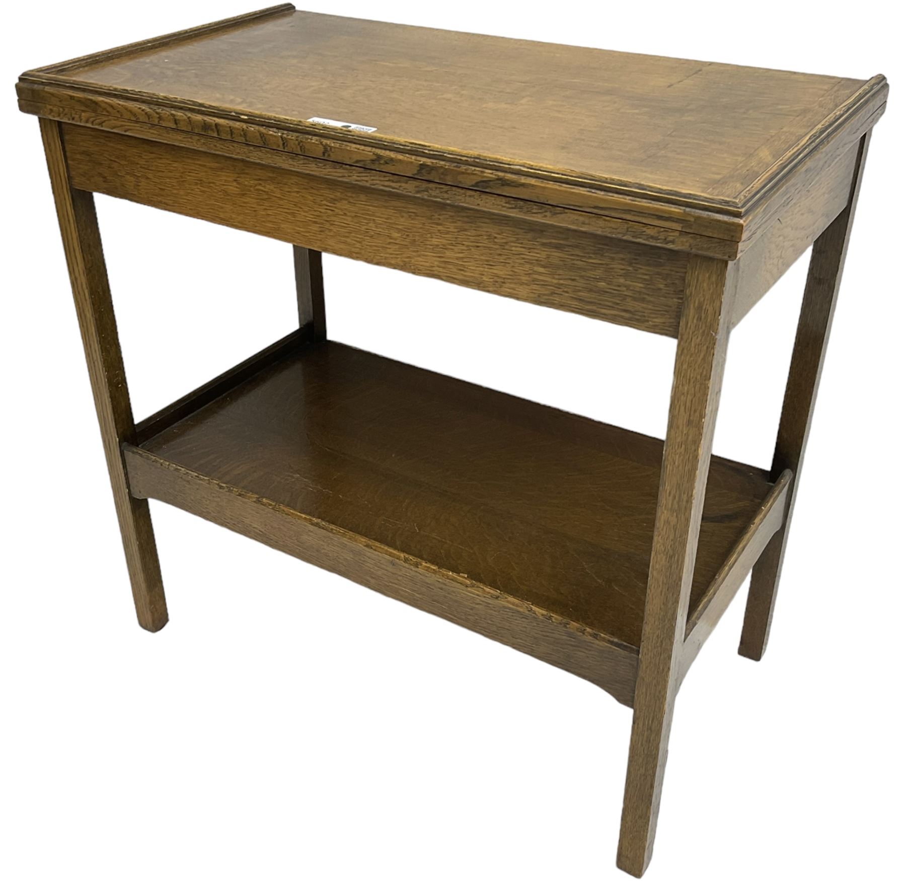 Early 20th century oak card table, fold-over and swivel rectangular top with baize lining, square supports united by undertier 
