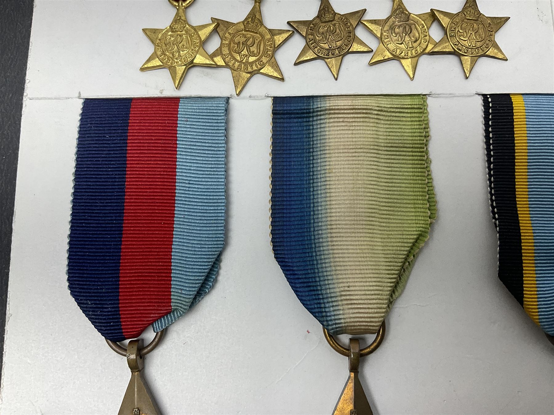 Representative display of WWII Campaign stars comprising 1939-1945 Star, Atlantic Star, Air-Crew Europe Star, Africa Star and Pacific Star; together with the corresponding group of miniatures; all with ribbons