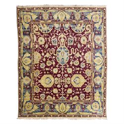 Agra design wool carpet, burgundy field decorated with large scrolling floral vines, palme...
