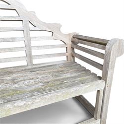 Lutyens design teak garden bench, shaped arched and slatted back over rolled arms and slatted seat, raised on square supports with box-stretcher