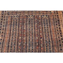North Persian indigo ground tribal rug, the field decorated with stylised geometric motifs within vertical rows, the guard stripes with repeating hook motifs